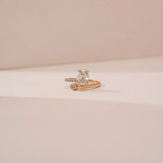 Front view of Reia’s 14 KT Yellow Gold Orbit Spark Diamond Solitaire Ring. Captured on a cream backdrop, it highlights the 1.3 carat oval solitaire and its refined, enduring elegance.