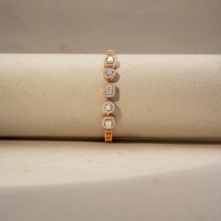 Front view of a diamond station bracelet in 14 KT Rose Gold, featuring alternating round and emerald-cut lab-grown diamonds framed by sparkling halo settings, displayed on a beige surface.
