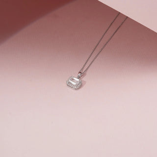Top view of an emerald-cut diamond pendant in 14KT White Gold, featuring a diamond halo and a delicate chain.