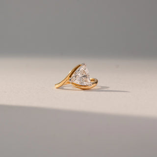 Angled view of Trillion Solitaire Diamond Ring in 14KT Yellow Gold, featuring a centred trillion-cut lab grown diamond in prong setting. Set on a neutral backdrop, the design highlights sculpted curves and brilliance.
