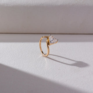 Side view of Trillion Solitaire Diamond Ring in 14KT Yellow Gold, featuring a centred trillion-cut lab grown diamond in prong setting. Set on a beige backdrop, the design highlights structure and refined brilliance.