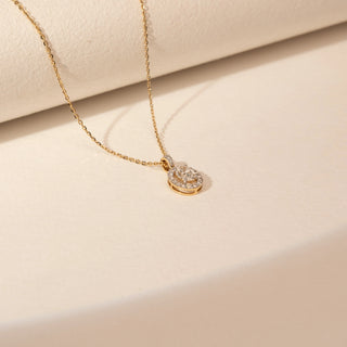 Side view of a 14KT Yellow Gold diamond pendant with an oval centre diamond, diamond-set halo and a diamond-set bail.