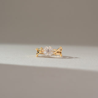 Front view of floral cluster diamond ring in yellow gold, featuring pear-shaped lab-grown diamonds arranged in a petal formation with an open layered band. Set on a soft neutral backdrop, it reflects delicate brilliance.