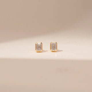 Front view of 14KT Yellow Gold diamond earrings, featuring rectangular step-cut diamonds in bezel settings.