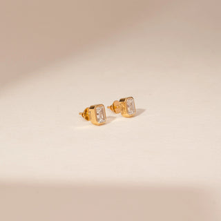 Side view of 14KT Yellow Gold diamond earrings, featuring rectangular step-cut diamonds in bezel settings.