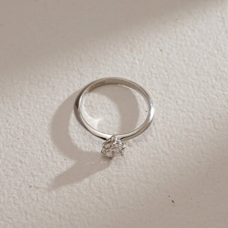 Top view of Moonlit Solitaire Diamond Engagement Ring against beige background. Made in 14KT hallmarked white gold, size 12, showcasing EF VVS lab grown solitaire diamond weighing 0.56 carats. Ring weight 1.81 grams, priced INR 15,000–50,000.