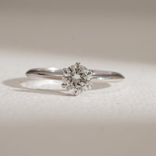 Front view of Moonlit Solitaire Diamond Engagement Ring photographed on beige background. 14KT hallmarked white gold, size 12, with EF colour, VVS clarity lab grown solitaire diamond weighing 0.56 carats. Ring weighs 1.81 grams, price INR 15,000–50,000.