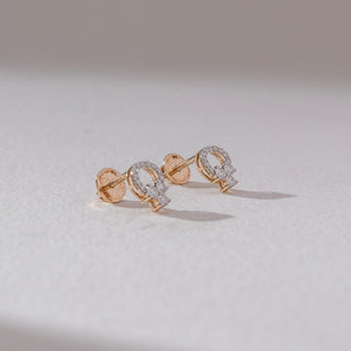 Angled back view of floral cluster diamond stud earrings in yellow gold, showing screw backs and round lab-grown diamonds in a petal cluster with halo detail. Set on a soft neutral surface, it highlights structure and finish.