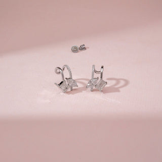 Angled view of 14KT White Gold diamond drop earrings with baguette and marquise-cut diamonds.
