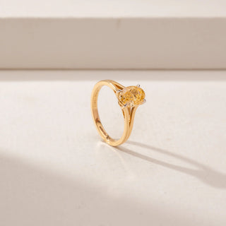 Angled view of a diamond ring in 14KT Yellow Gold, featuring alternating oval diamond in a beige backdrop.