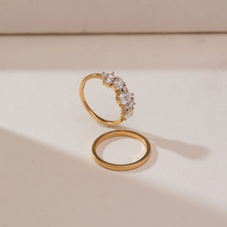 Angled view of Asymmetric Multi-Shape Diamond Ring in 14KT yellow gold, showcasing an oval centre diamond with varied diamond shapes, displayed above a plain gold band.