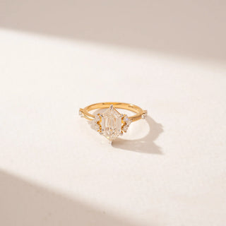Close-up view of a 14KT Yellow Gold diamond ring featuring a duchess marquise diamond, marquise accents and delicate pavé detailing.