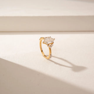 Angled view of a 14KT Yellow Gold diamond ring featuring a duchess marquise diamond, marquise accents and delicate pavé detailing.