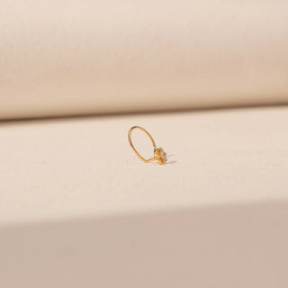 Side view of Floral Diamond Nosepin in 14KT Yellow Gold, featuring a floral diamond motif on a delicate open hoop.