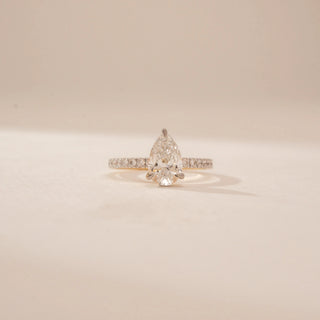 Front view of a 14KT Yellow Gold diamond ring, featuring pear and round diamonds with a diamond-set band.