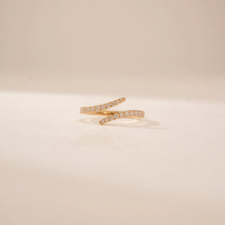 Front view of a 14KT Yellow Gold diamond ring, featuring round diamonds on two curved open bands.