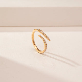 Angled view of a 14KT Yellow Gold diamond ring, featuring round diamonds on two curved open bands.