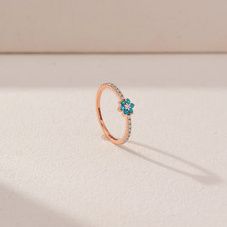 Angled view of Blue Floral Gemstone Ring in 14KT Rose Gold, featuring blue round gemstones and round lab-grown diamonds.