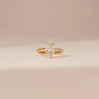 Front view of a 14KT Yellow Gold diamond ring with a marquise centre diamond in a four-prong setting.