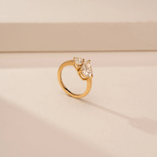 Angled view of Dazzling Pear Bypass Diamond Ring in 14KT Yellow Gold, featuring two pear-cut lab-grown diamonds.