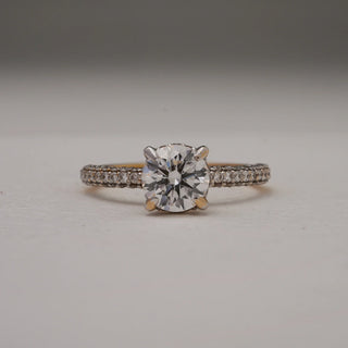 Close-up front view of Radiant Glow Solitaire Diamond Ring in 14KT Yellow Gold, showcasing a 0.6 carat round solitaire with pavé-set EF VVS diamonds on the band for timeless brilliance.