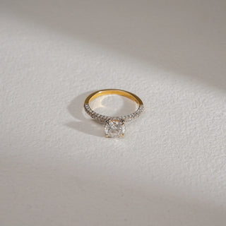 Top view of Radiant Glow Solitaire Diamond Ring in 14KT Yellow Gold, featuring a 0.6 carat round solitaire with pavé-set EF VVS diamonds on the band, symbolizing timeless elegance.