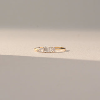 Front view of Baguette Diamond Band Ring in 14KT Yellow Gold, featuring a row of baguette-cut lab grown diamonds in prong setting. Set on a beige backdrop, the design highlights clean lines and refined brilliance.
