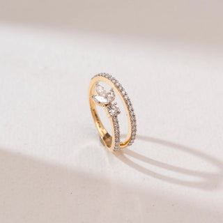 Angled view of the Marquise Leaf Cluster Diamond Ring in 14KT yellow gold, featuring marquise-cut diamonds forming a leaf cluster with a round center stone and a pavé diamond band on a neutral background.