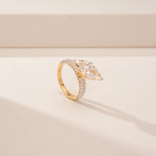 Angled view of a 14KT Yellow Gold diamond ring, featuring two marquise-cut diamonds and a diamond-set band.