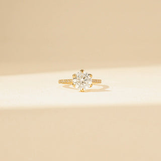 Front view of Round Solitaire Diamond Ring in 14KT Yellow Gold, featuring a round centre diamond and pavé-set band.