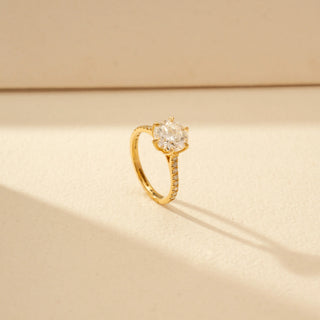 Angled view of Round Solitaire Diamond Ring in 14KT Yellow Gold, featuring a round centre diamond and pavé-set band.