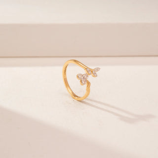 Angled view of a 14KT Yellow Gold diamond ring, featuring marquise and round diamonds in a floral design.