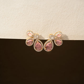 Front view of pink gemstone stud earrings in 14 KT Yellow Gold, featuring pear-shaped pink stones accented with halo-set diamonds in a floral-inspired arrangement against a neutral backdrop.

