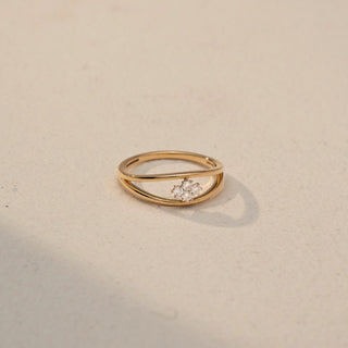 Side view of a Trio Diamond Cluster Ring in 14KT Yellow Gold, featuring three round lab-grown diamonds in a floral cluster on a double-band design. Captured against a beige backdrop with soft shadow.
