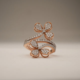 Rose gold Twin Flower Diamond Ring in hallmarked 14 KT gold, featuring two floral motifs set with EF colour, VVS clarity lab grown diamonds. Front view shows intricate dual flower design with pavé-set diamonds along the split shank, highlighting brilliance and symmetry against a neutral backdrop.