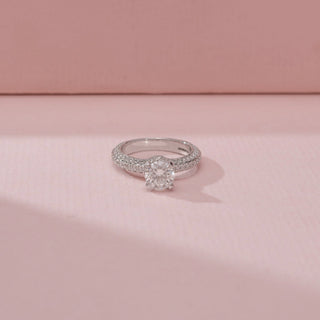 Close-up view of a 14KT White Gold diamond ring, featuring a cushion-cut centre diamond and diamond-set band.