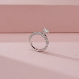 Angled view of a 14KT White Gold diamond ring, featuring a cushion-cut centre diamond and diamond-set band.