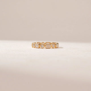 Front view of a 14KT Yellow Gold diamond eternity ring featuring alternating round and rectangular bezel-set diamonds in a continuous pattern.