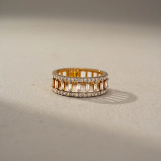 Front view of a geometric diamond statement band in 14 KT Yellow Gold, featuring vertically set baguette-cut lab-grown diamonds framed by pavé-set round diamond rows in an openwork design, displayed against a beige backdrop.