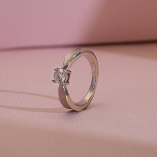 Side angle of Solitaire Knot Lab-Grown Diamond Engagement Ring on soft pink backdrop. 14KT hallmarked white gold, size 11, with EF VVS solitaire diamond weighing 0.42 carats. Weighs 3.55 grams, priced INR 15,000–50,000.