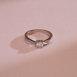 op view of Solitaire Knot Diamond Engagement Ring photographed against pastel pink background. Size 11, made in 14KT white gold with EF colour, VVS clarity 0.42-carat solitaire lab-grown diamond. Weighs 3.55 grams, price INR 15,000–50,000.