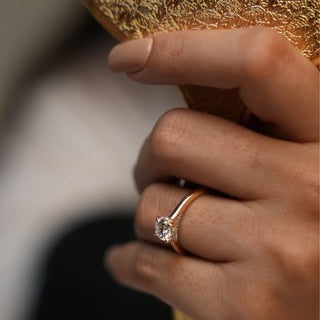 Displayed on a female model hand, This female ring of size 12 features a brilliant 0.86-carat lab-grown diamond set in 14 KT yellow gold weighing a total of 2.89 grams. The solitaire diamond is the centrepiece, showcasing its brilliance and timeless elegance. In this close-up view, the ring's exquisite design and sparkling diamond are highlighted, emphasizing its classic luxury and refined sophistication.