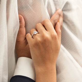 Top view of a 1.188-carat Lab Grown Diamond female Ring in 14 KT white gold weighing a total of 3.34 grams of size 12. The ring is elegantly displayed on a model's hand, offering a top-view perspective. The central round brilliant diamond is prominently featured, surrounded by smaller diamonds along the pave band, which adds extra sparkle and sophistication to the design.