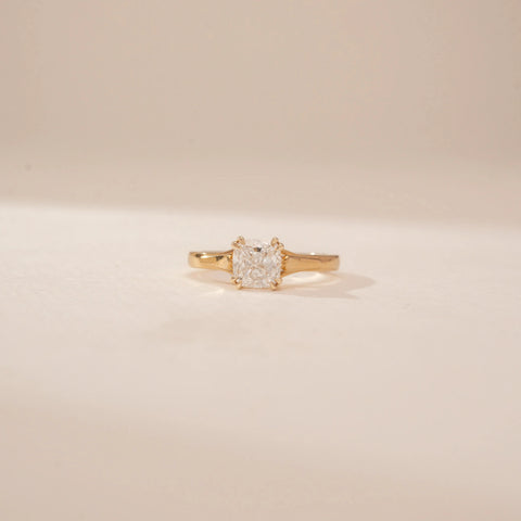 Front view of a 14KT Yellow Gold diamond ring with a square centre diamond and plain tapered band.