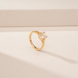 Angled view of a 14KT Yellow Gold diamond ring with a square centre diamond and plain tapered band.
