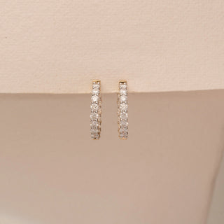 Front view of 14KT Yellow Gold diamond earrings, featuring vertical rows of round diamonds in slim settings.