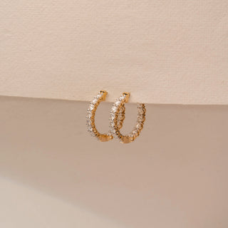 Angled view of 14KT Yellow Gold diamond earrings, featuring vertical rows of round diamonds in slim settings.