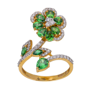 A front view of a female ring of size 14 weighing 4.26 grams is displayed on a white background, showcasing an intricate design. Crafted from 14 KT yellow gold and 0.435-carat lab-grown diamond, it is complemented by vibrant green gemstones, arranged in an elaborate floral pattern. The ring's elegant composition features delicate diamond accents that accentuate the radiant gems, creating a captivating look.