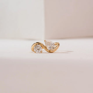 Front view of Serpentine Duo Diamond Ring in 14KT yellow gold, featuring a round and pear-cut diamond set on a graceful S-shaped Toi et Moi bypass band.