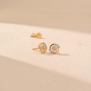 Angled view of Floral Cluster Diamond Stud Earrings in 14KT Yellow Gold, featuring round diamond clusters with curved pavé arcs.